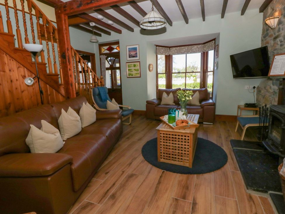A living room with a sofa and coffee table at Parrog Stores near Newport, Pembrokeshire
