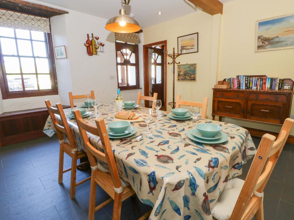 A dining room with a table set for meal at Parrog Stores near Newport, Pembrokeshire