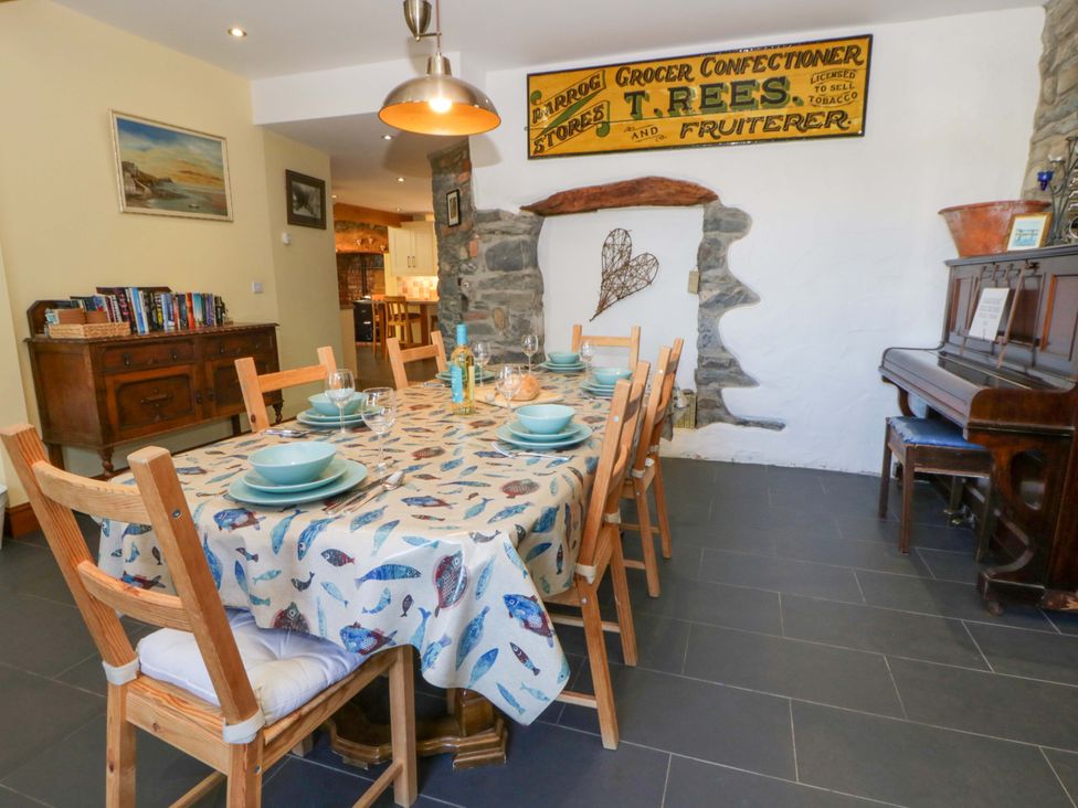 A dining room with a large table and chairs at Parrog Stores Parrog near Newport, Pembrokeshire