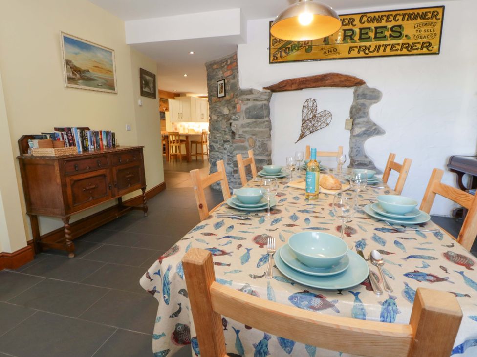A dining room with a table set for dinner at Parrog Stores near Newport, Pembrokeshire