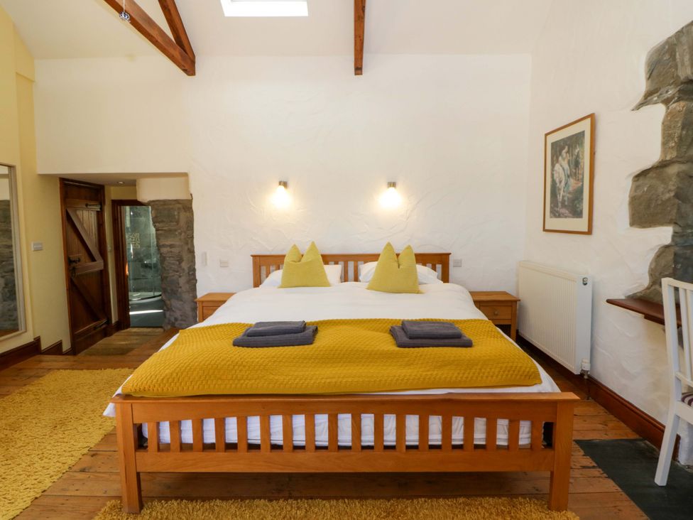 A bedroom with a double bed and en suite bathroom at Parrog Stores Parrog near Newport, Pembrokeshire