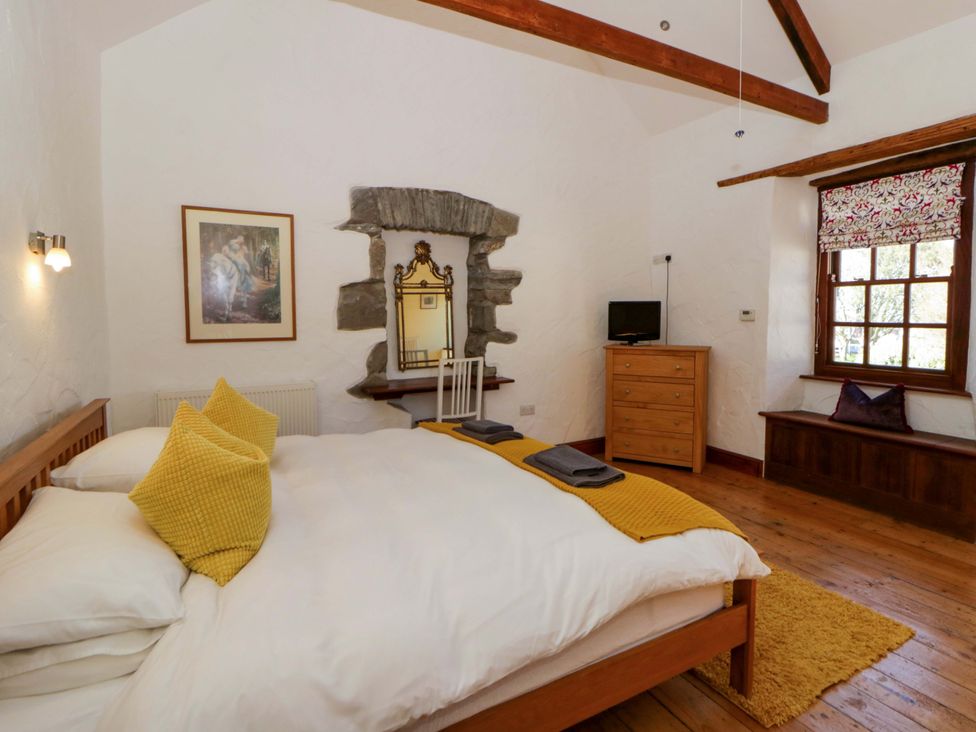 A bedroom with a bed and chest of drawers at Parrog Stores near Newport, Pembrokeshire