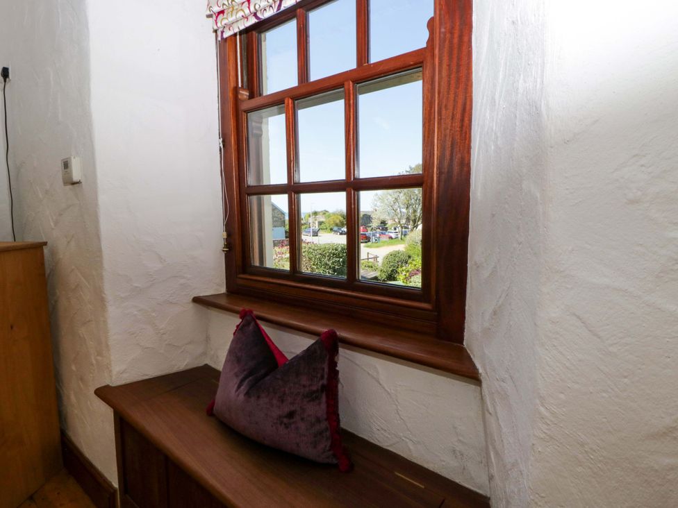 A window with a cushion on the sill at Parrog Stores near Newport, Pembrokeshire