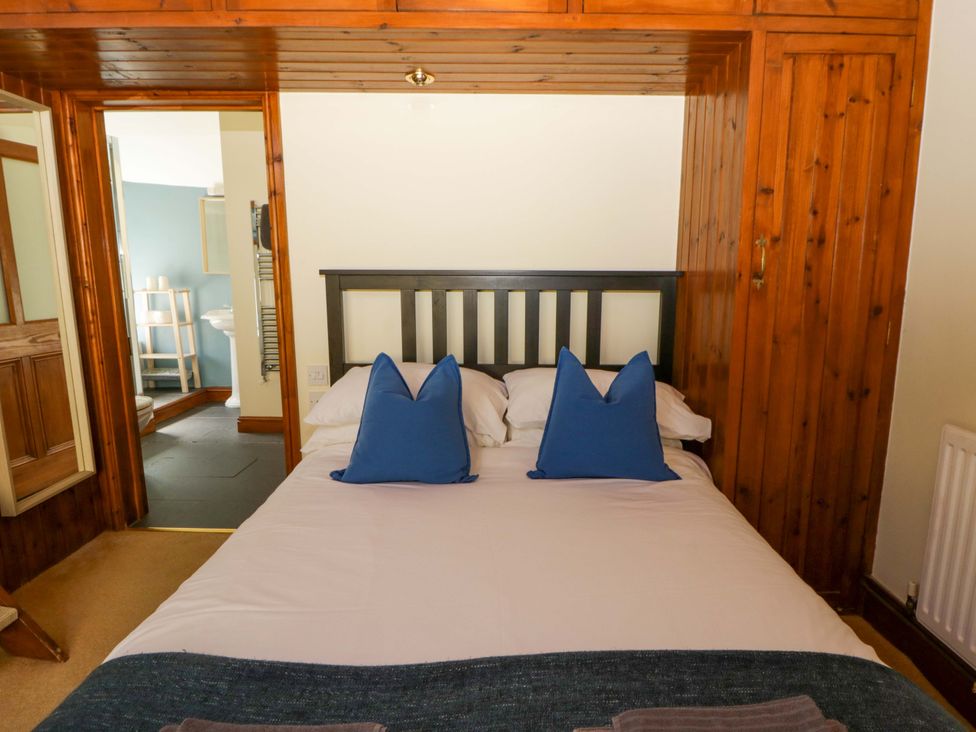 A bedroom with a bed and pillows at Parrog Stores Parrog near Newport, Pembrokeshire