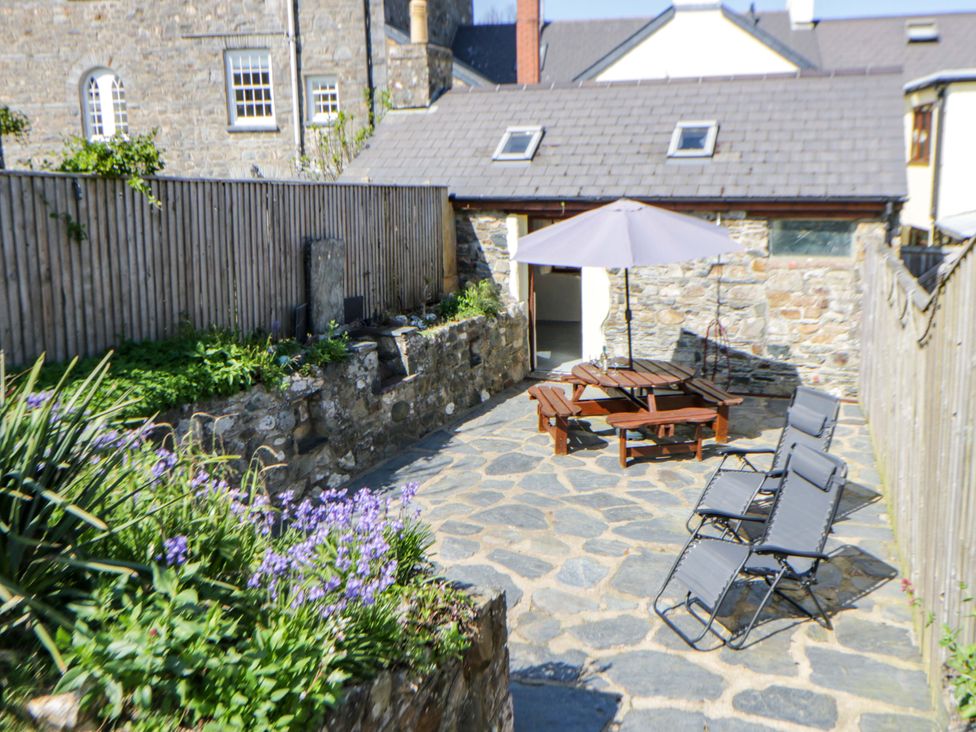 An outdoor area with a table and chairs at Parrog Stores near Newport, Pembrokeshire
