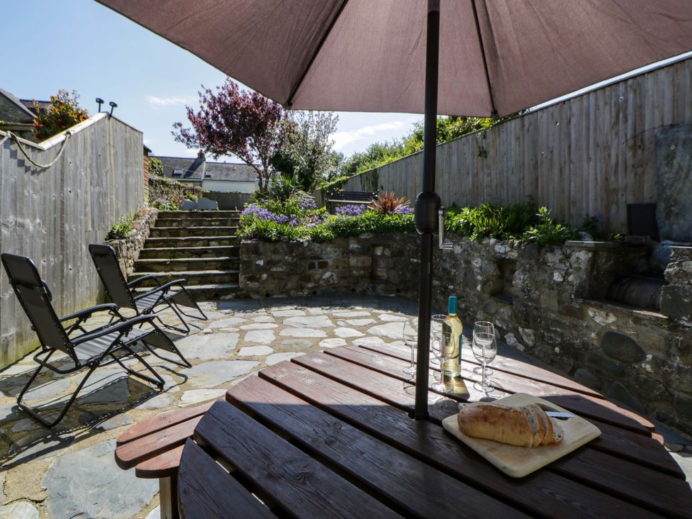 A garden with a table and chairs at Parrog Stores Parrog near Newport Pembrokeshire