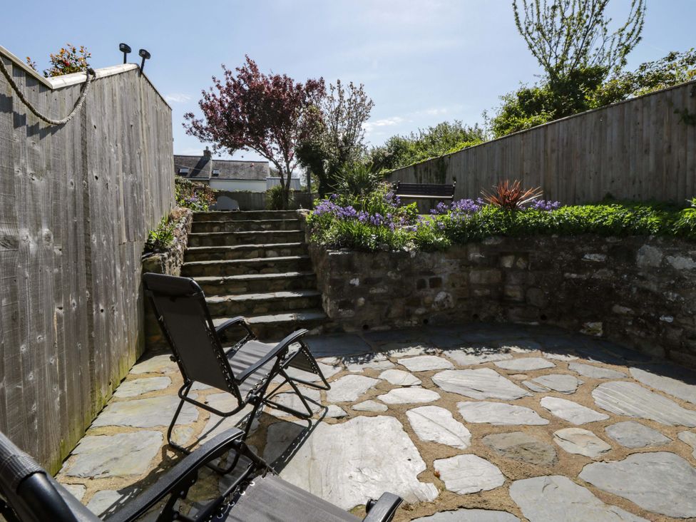 A garden with stone steps and seating area at Parrog Stores Parrog near Newport, Pembrokeshire