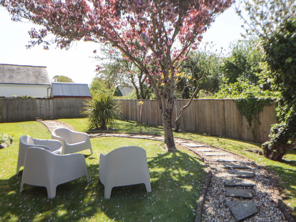 A garden with chairs and a pathway at Parrog Stores, Parrog near Newport, Pembrokeshire