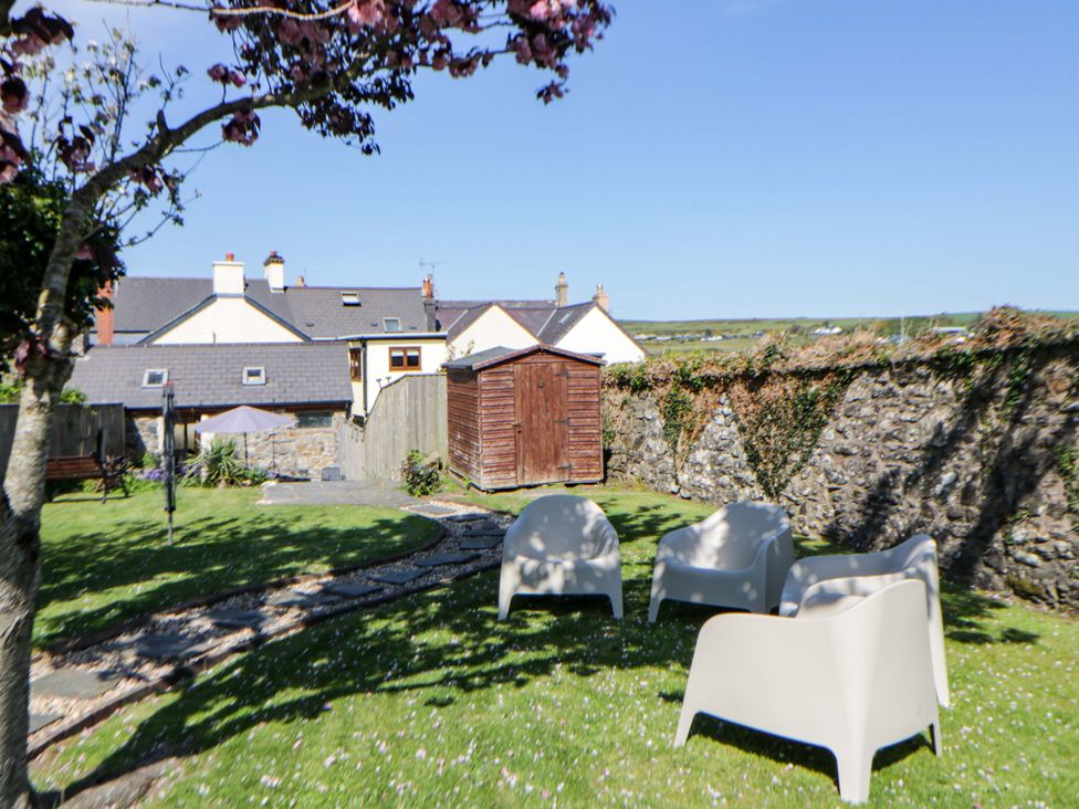 A garden with seating and a shed at Parrog Stores in Parrog near Newport, Pembrokeshire