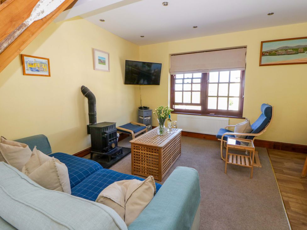 A living room with a sofa and television at Parrog Bach Parrog near Newport, Pembrokeshire
