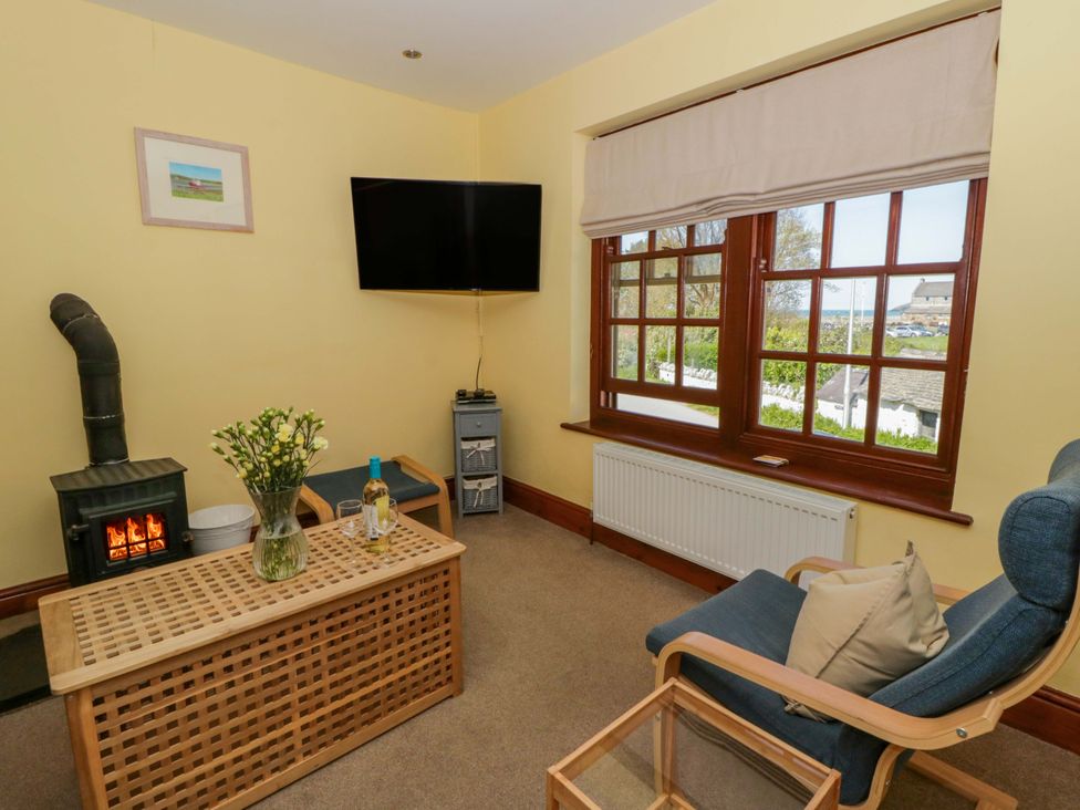 A living room with a television and seating area at Parrog Bach in Parrog near Newport, Pembrokeshire
