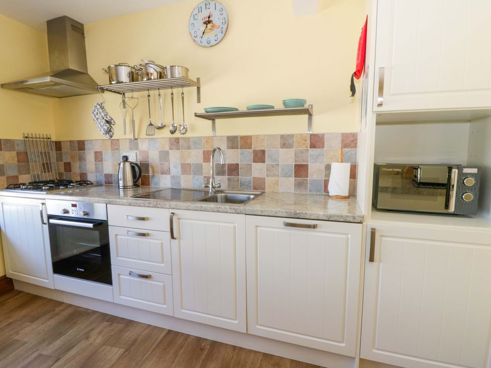 A kitchen with a sink and stove at Parrog Bach near Newport, Pembrokeshire