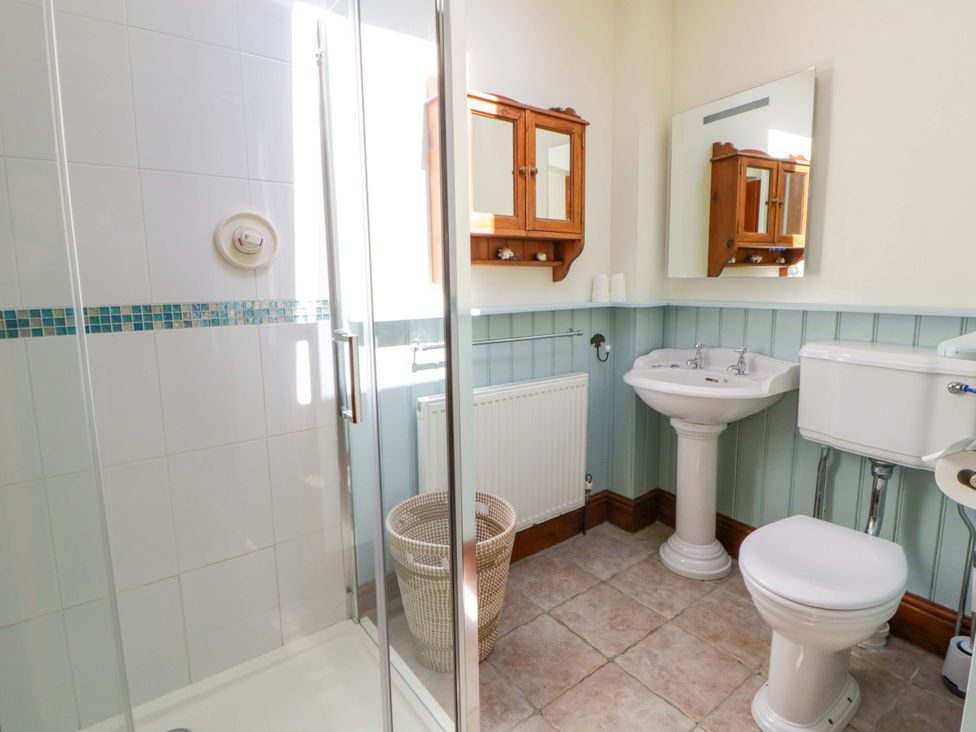 A bathroom with a shower, sink, and toilet at Parrog Bach, Parrog near Newport, Pembrokeshire