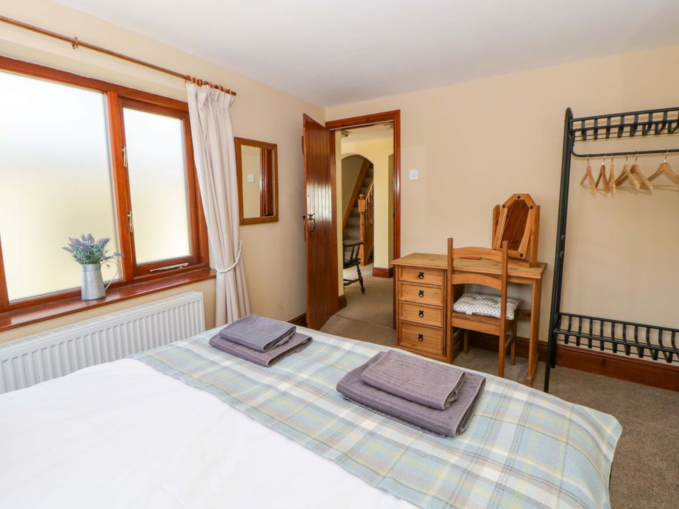 A bedroom with a bed and furniture at Parrog Bach near Newport, Pembrokeshire