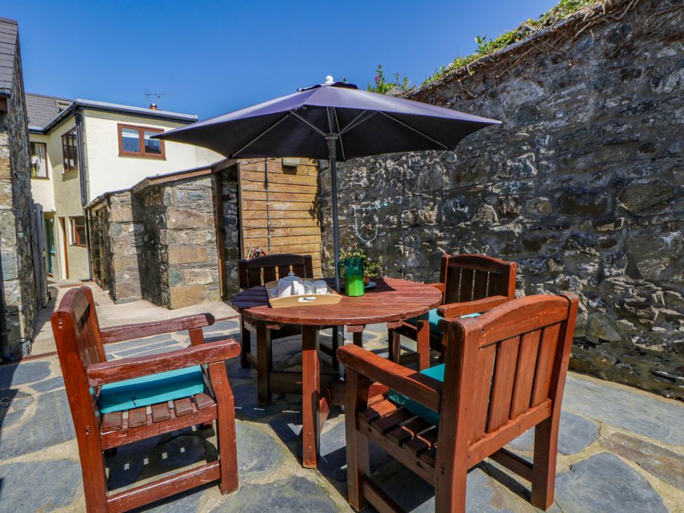 An outdoor seating area with a table and chairs at Parrog Bach near Newport, Pembrokeshire
