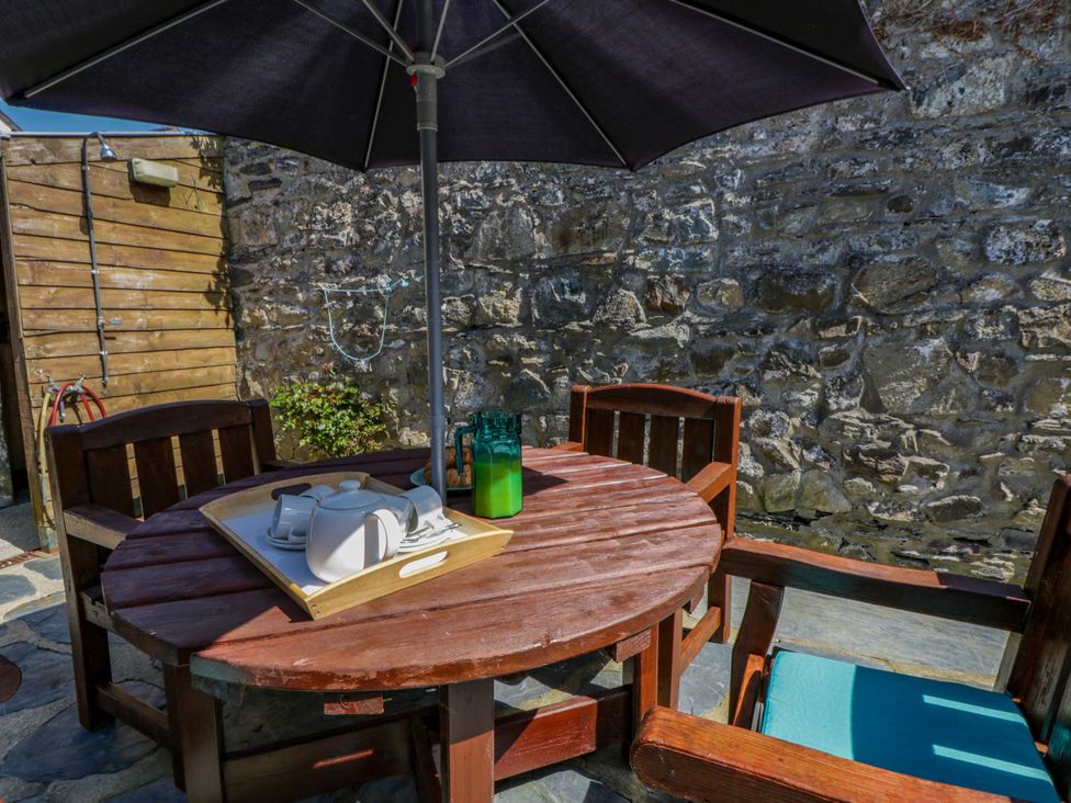 A table with chairs and an umbrella at Parrog Bach Parrog near Newport, Pembrokeshire