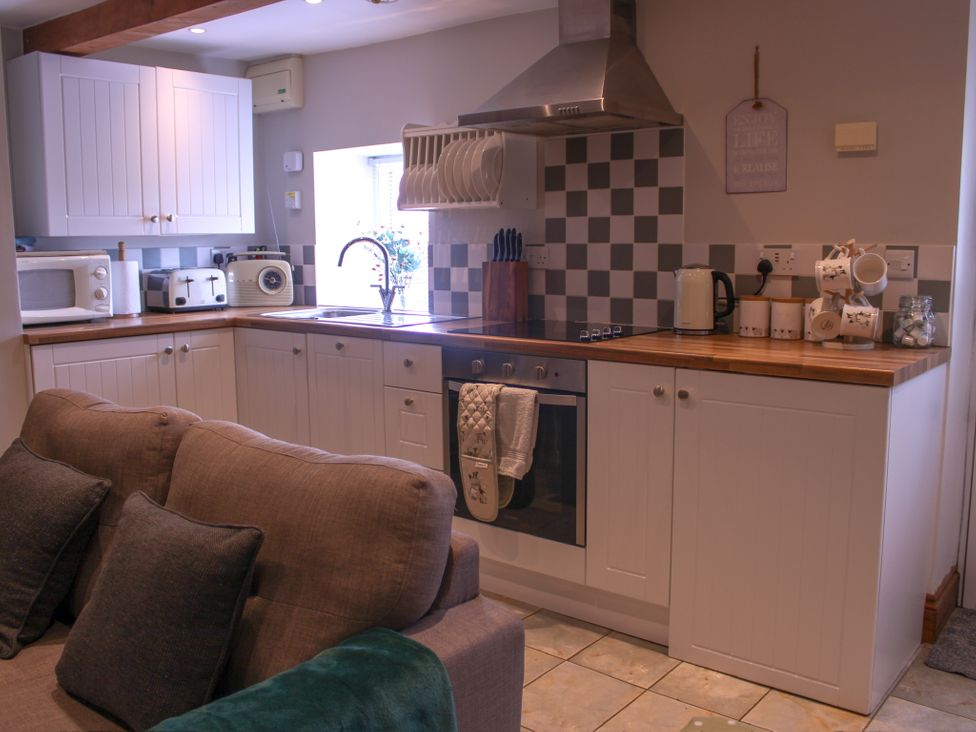 A kitchen with countertop appliances and cabinetry at School House Cottage Newtown near Longnor