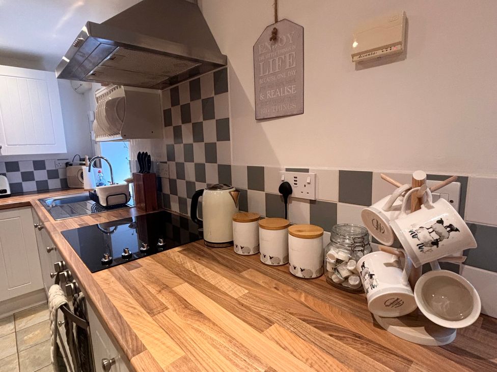 A kitchen with various utensils and appliances at School House Cottage in Newtown near Longnor