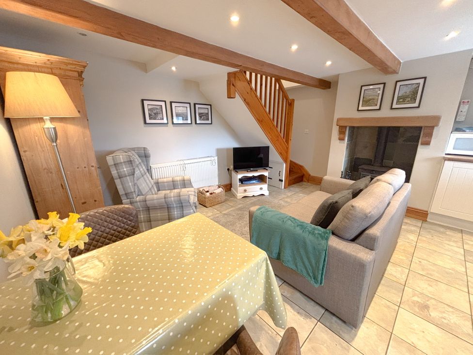 A living room with a sofa and coffee table at School House Cottage in Newtown near Longnor