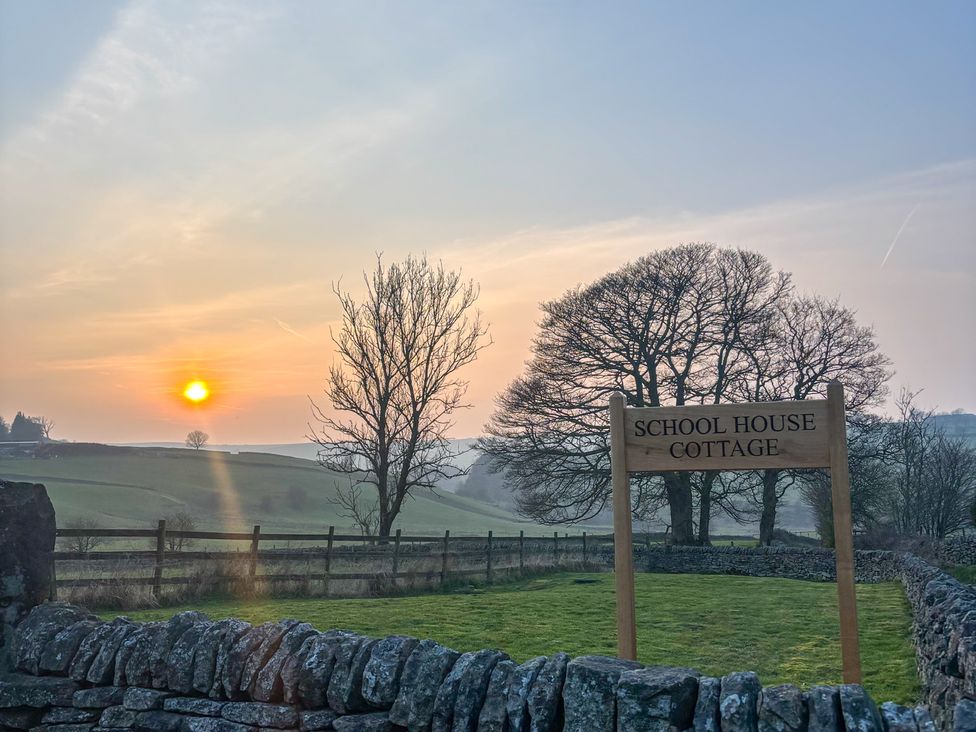 A sunset with a sign at School House Cottage in Newtown near Longnor