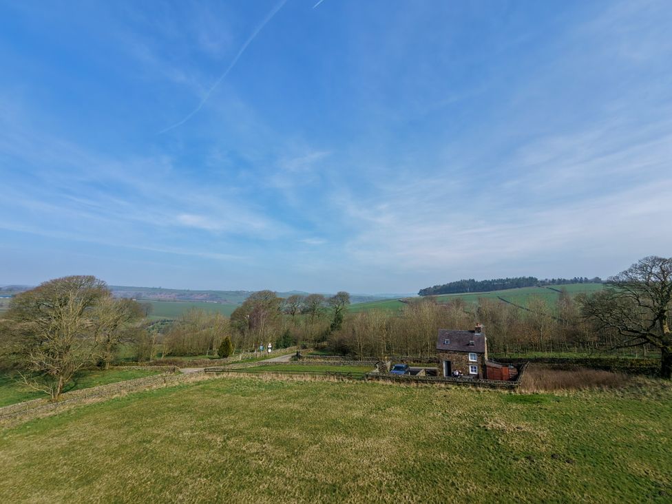 A view of a house in the countryside at School House Cottage in Newtown near Longnor