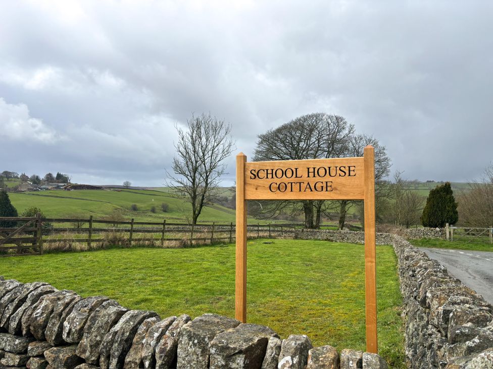 A sign for School House Cottage in Newtown near Longnor