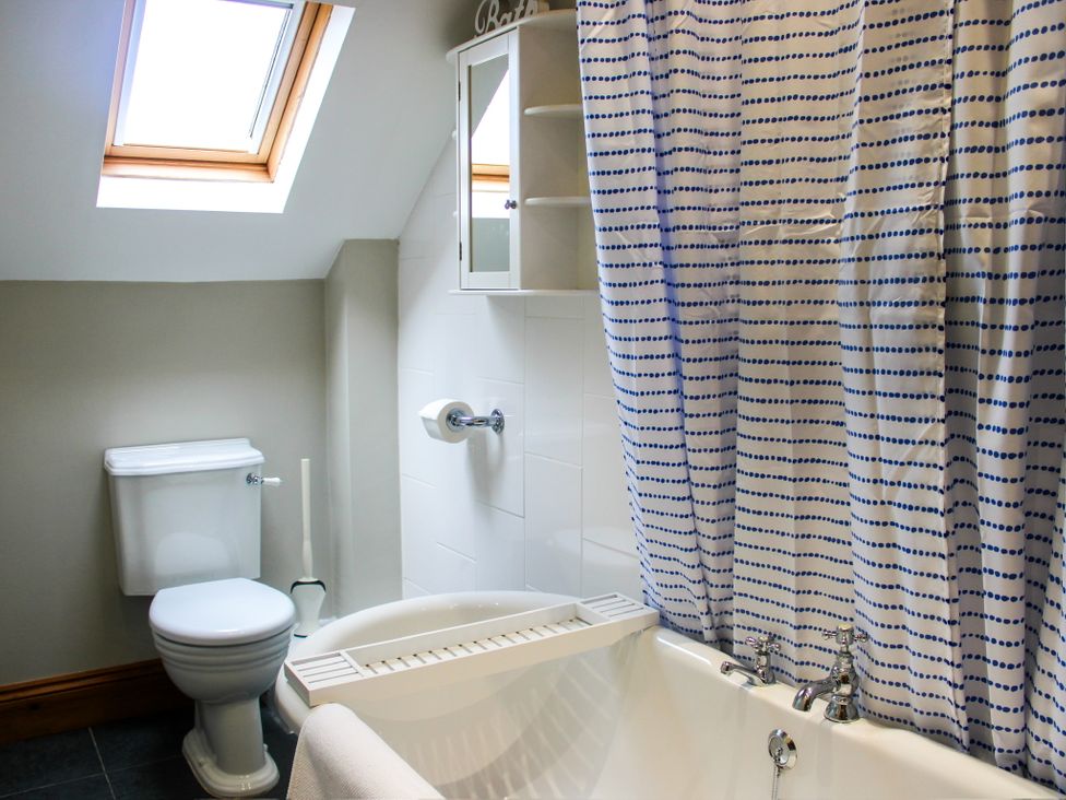 A bathroom with a bathtub and toilet at School House Cottage, Newtown near Longnor