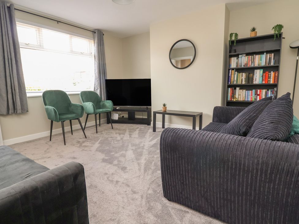 A living room with a sofa and armchairs at 7 Grantham Road Southport