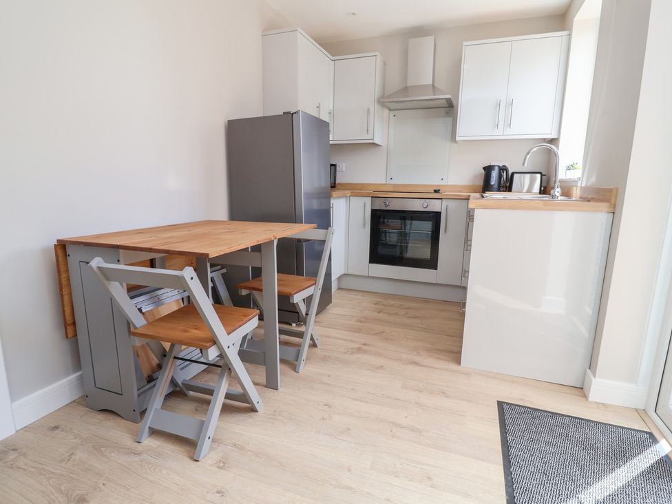 A kitchen with appliances and dining furniture at 7 Grantham Road in Southport