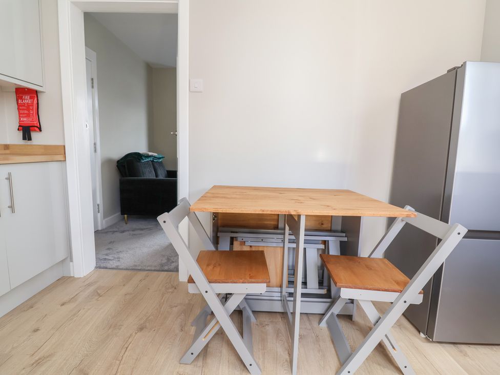 A kitchen with a table and chairs at 7 Grantham Road in Southport