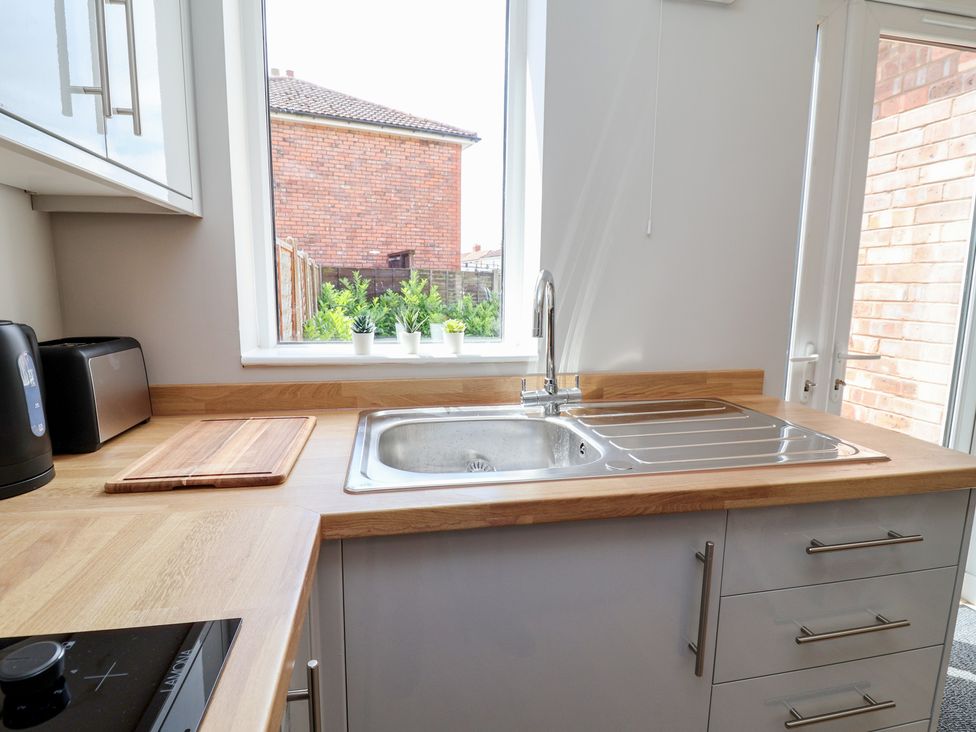 A kitchen with a sink and countertop at 7 Grantham Road Southport