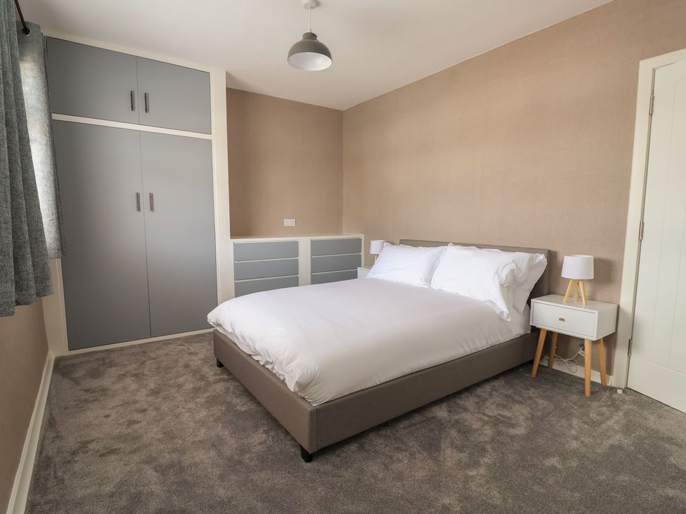 A bedroom with a bed and bedside table at 7 Grantham Road in Southport
