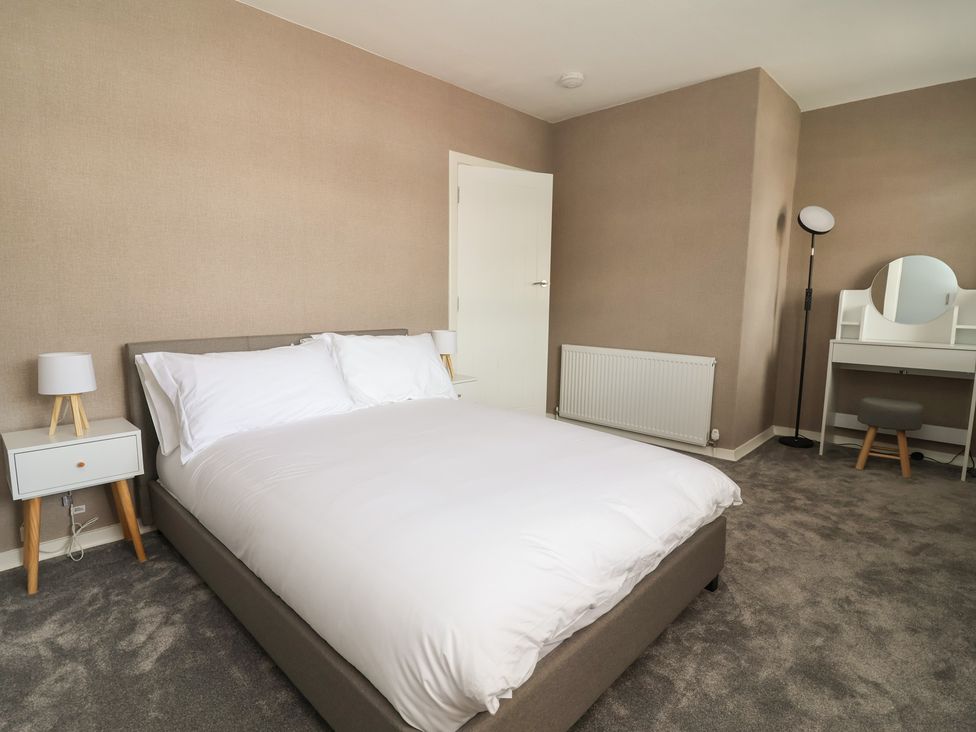 A bedroom with a bed and side table at 7 Grantham Road in Southport