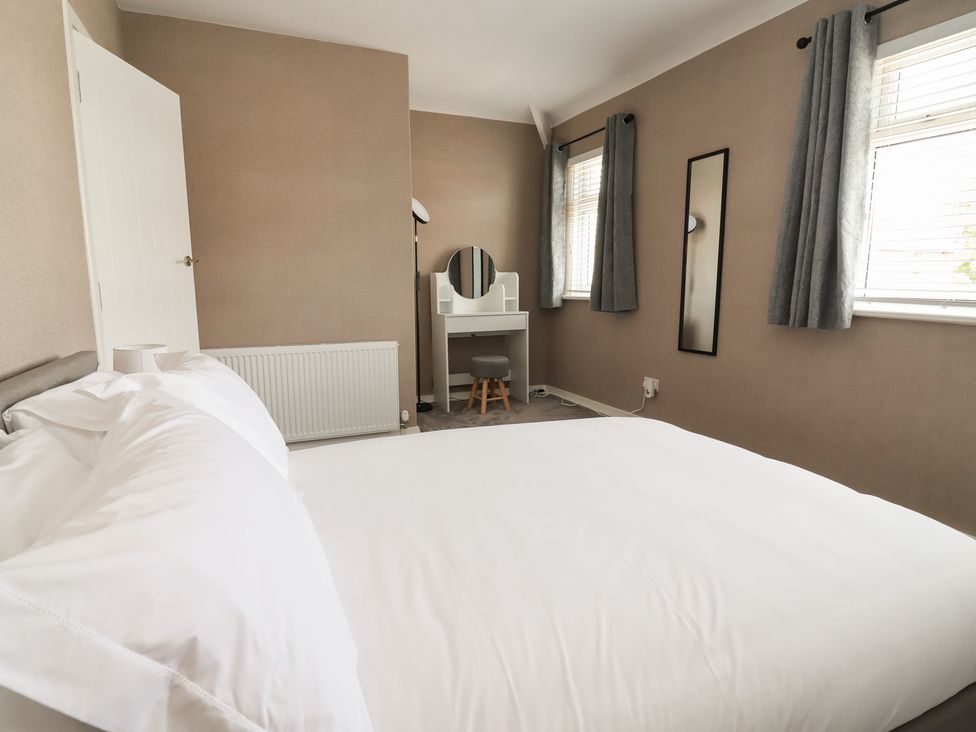 A bedroom with a bed and dressing table at 7 Grantham Road in Southport