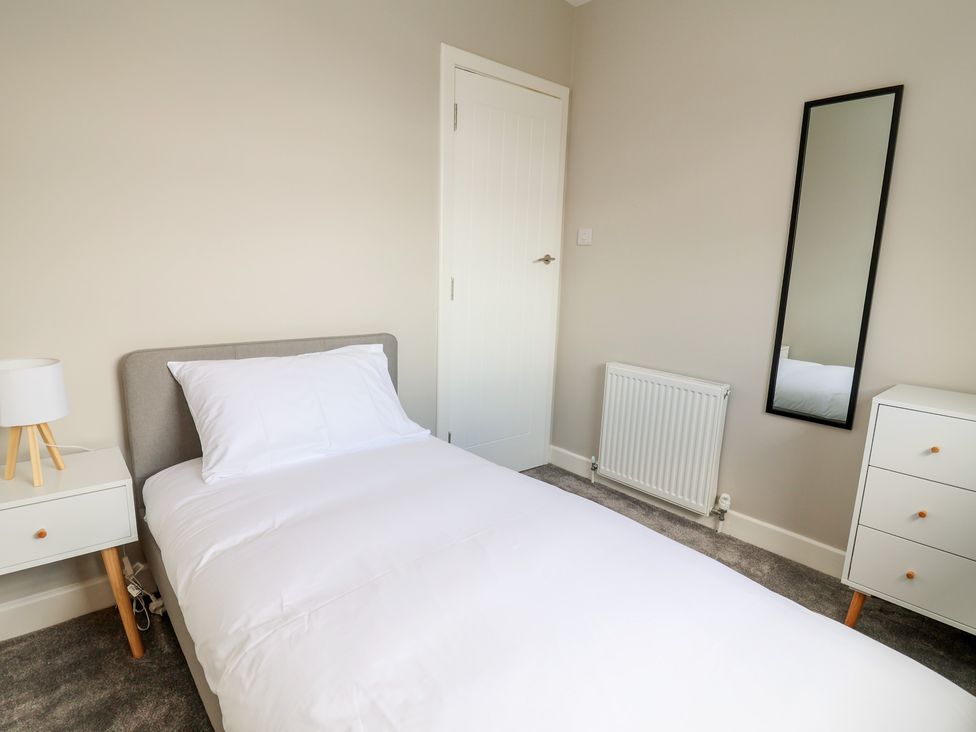 A bedroom with a single bed and furniture at 7 Grantham Road in Southport