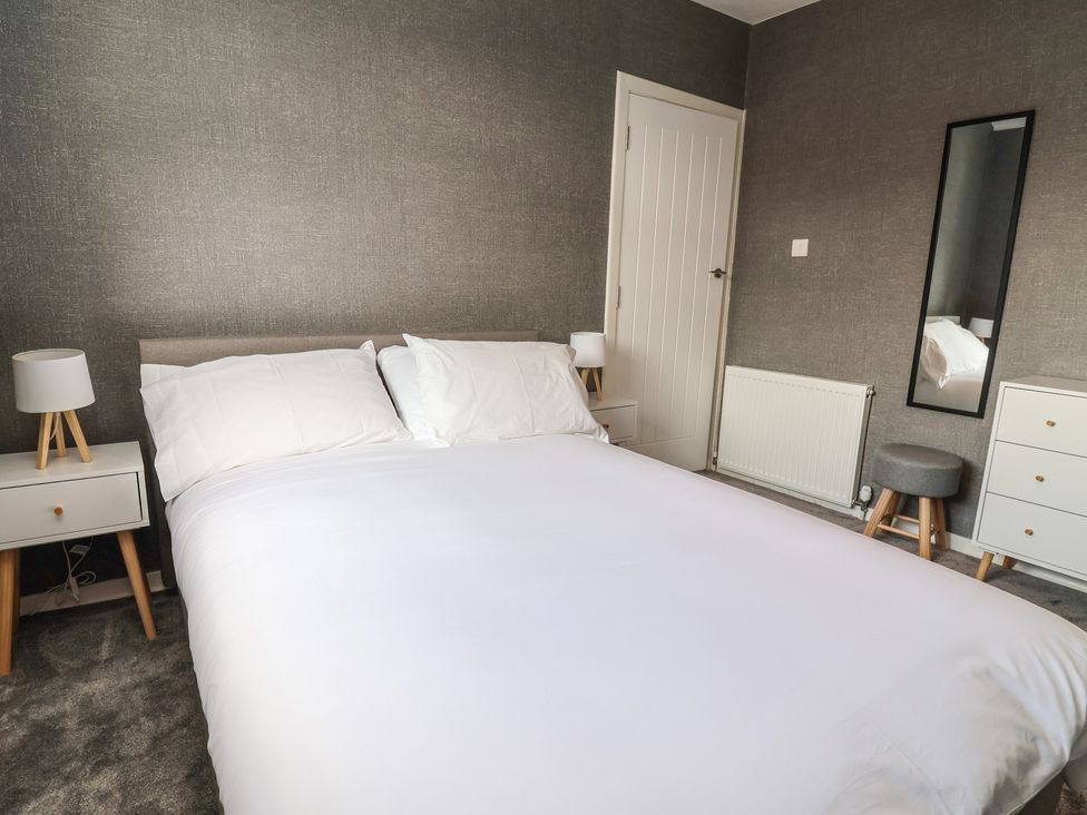 A bedroom with a double bed and nightstand at 7 Grantham Road, Southport