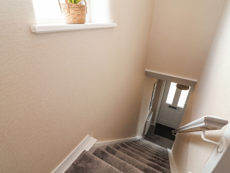 A staircase with a window and door at 7 Grantham Road in Southport