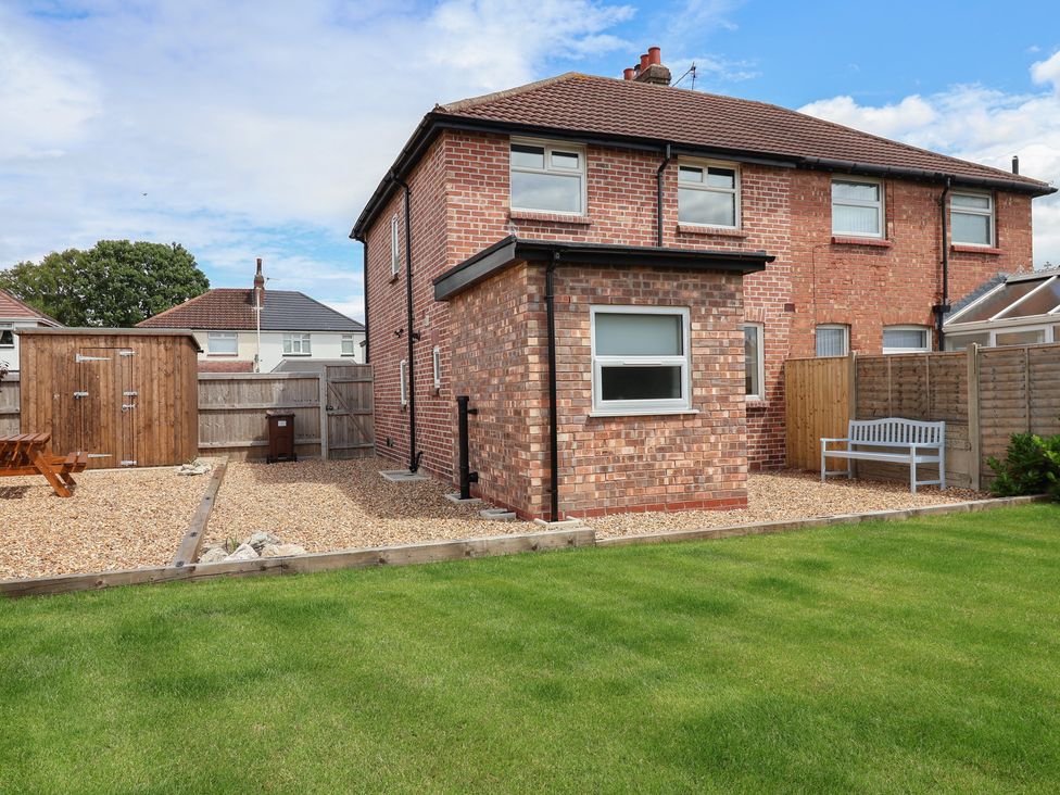 A garden with a house and a shed at 7 Grantham Road Southport