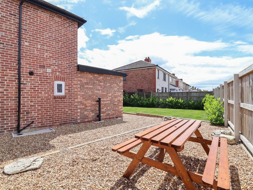 A garden with a table and gravel at 7 Grantham Road Southport