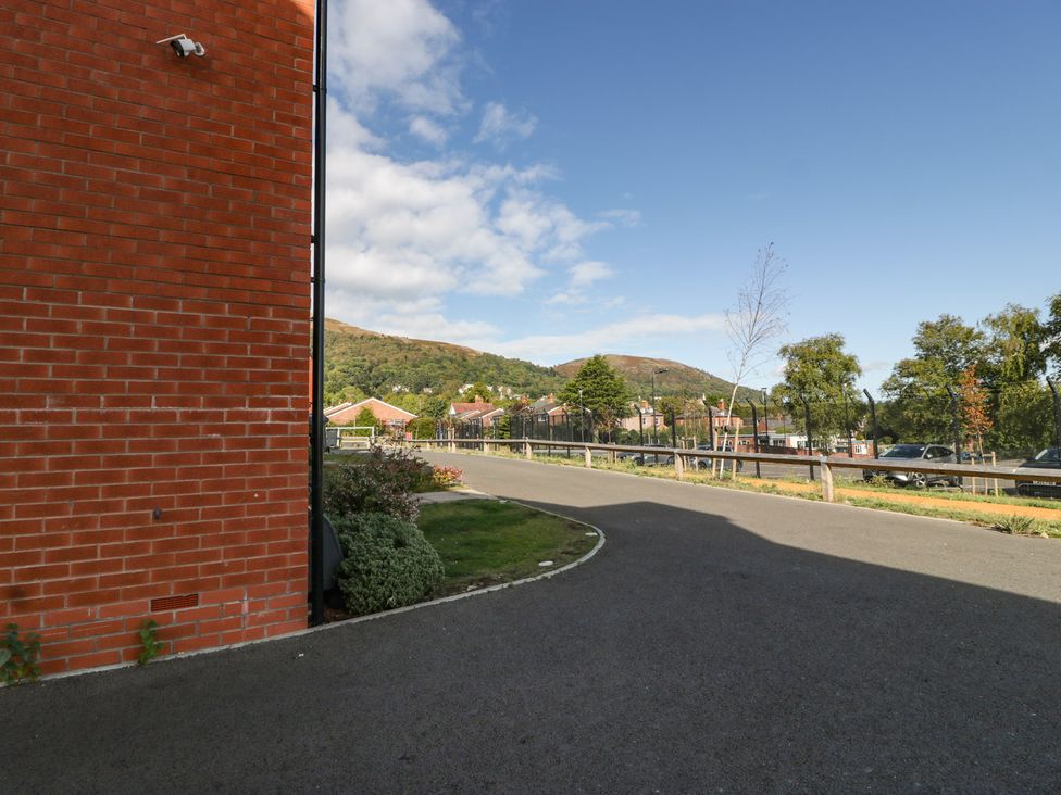 An outdoor view of a brick wall and road at 15 Hey Close Malvern
