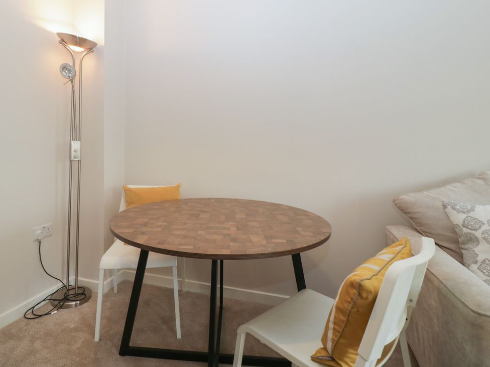 A dining area with a round table and two chairs at 15 Hey Close Malvern