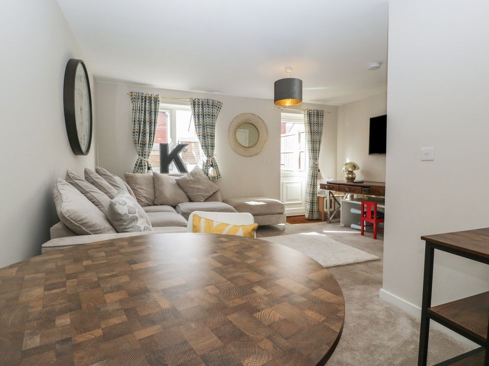 A living room with a sofa and table at 15 Hey Close Malvern