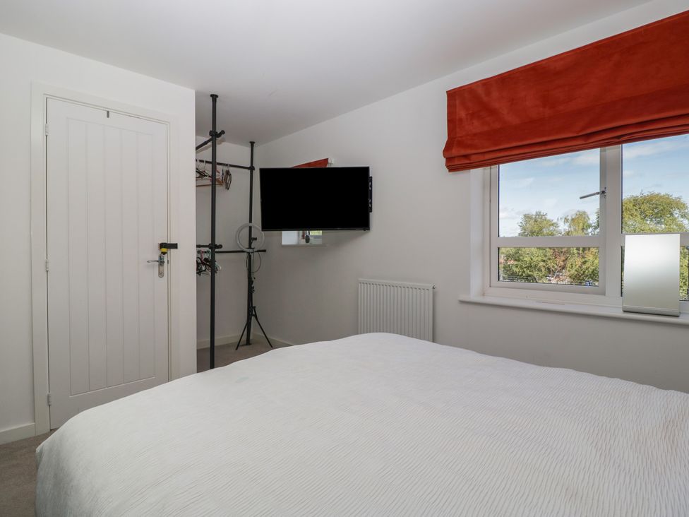 A bedroom with a bed and television at 15 Hey Close Malvern