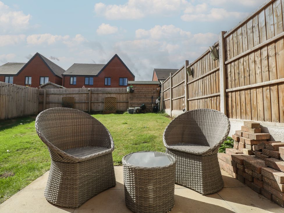 A garden with chairs and a table at 15 Hey Close in Malvern