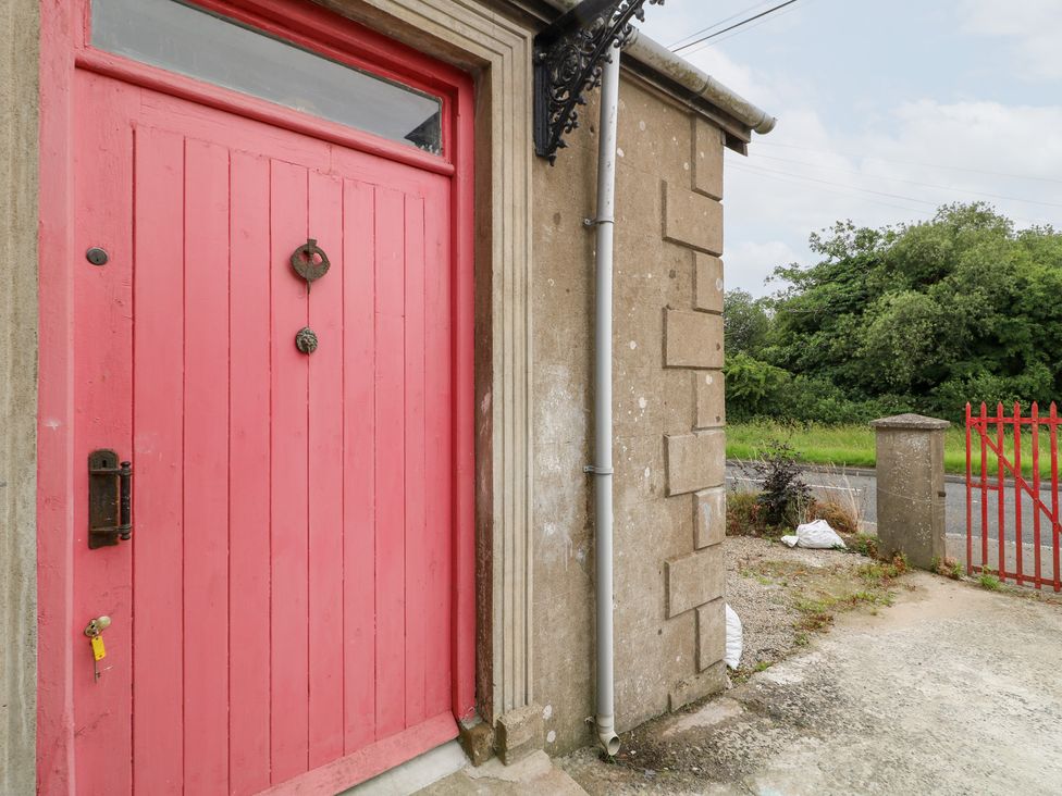 A pink door with a handle and knocker at Crea The Mission Hall near Ballymena