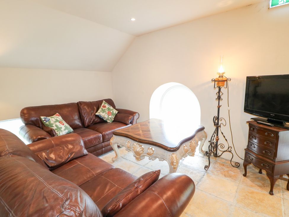 A living room with a sofa and coffee table at Crea The Mission Hall near Ballymena