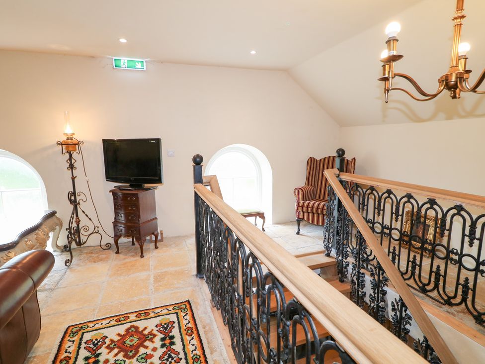 A landing with a staircase and seating area at Crea The Mission Hall near Ballymena