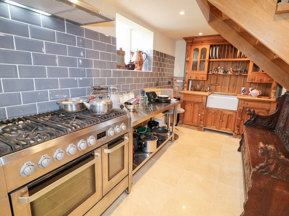 A kitchen with a stove and sink at Crea The Mission Hall near Ballymena