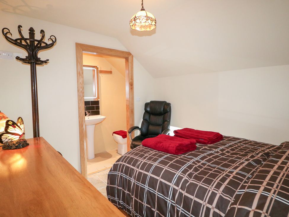 A bedroom with a bed and attached bathroom at Crea The Mission Hall near Ballymena