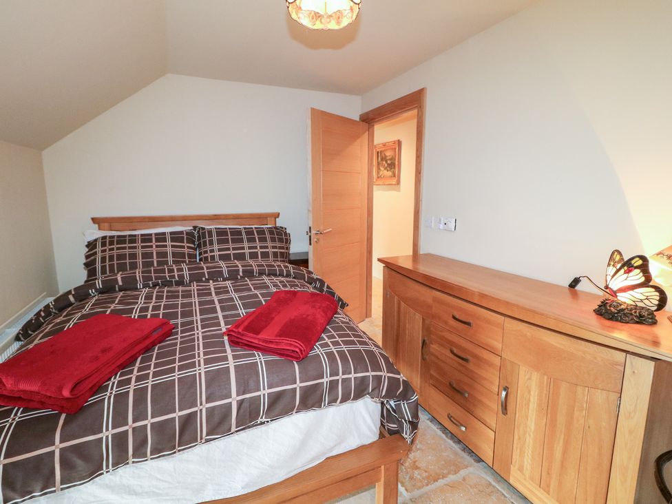 A bedroom with a bed and chest of drawers at Crea The Mission Hall near Ballymena